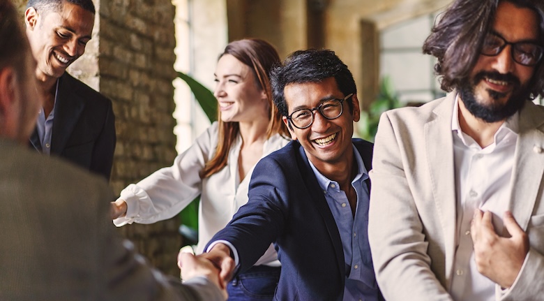 A happy smiling man shaking hands