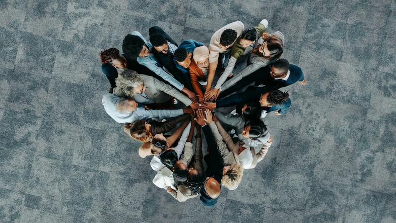 Top view of a a heart shape of people, showing unity and teamwork stock photo